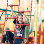kid climbing on playground, free standing play