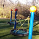 Group swings for playgrounds, saucer swings