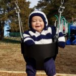 toddler swinging at the park, toddler swings, playground