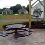 outdoor picnic area with table and swinging bench