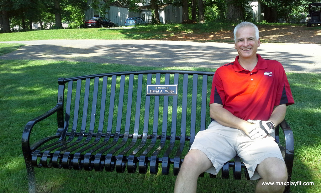 Pat McNamara on a memorial bench, playground equipment, site furnishings